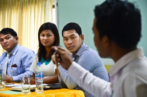 Ou Ratanak looks on as a student makes a point during a mock debate held to encourage critical thinking on gender issues among Cambodian youth