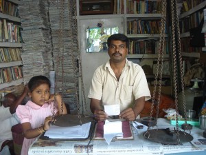 Scrap dealer Kishan Murthy with his little daughter at his shop
