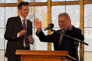 Two men behind a lectern