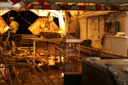Cleaning  the trawl deck of the RV Helmer Hanssen