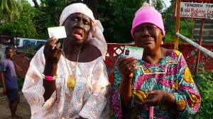 Two elderly woman show their voter ID