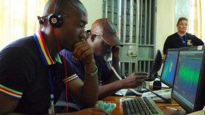 One reporter stares at a computer screen, the other is on the phone