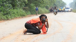 Phoro of a photographer kneeling on road taking photo